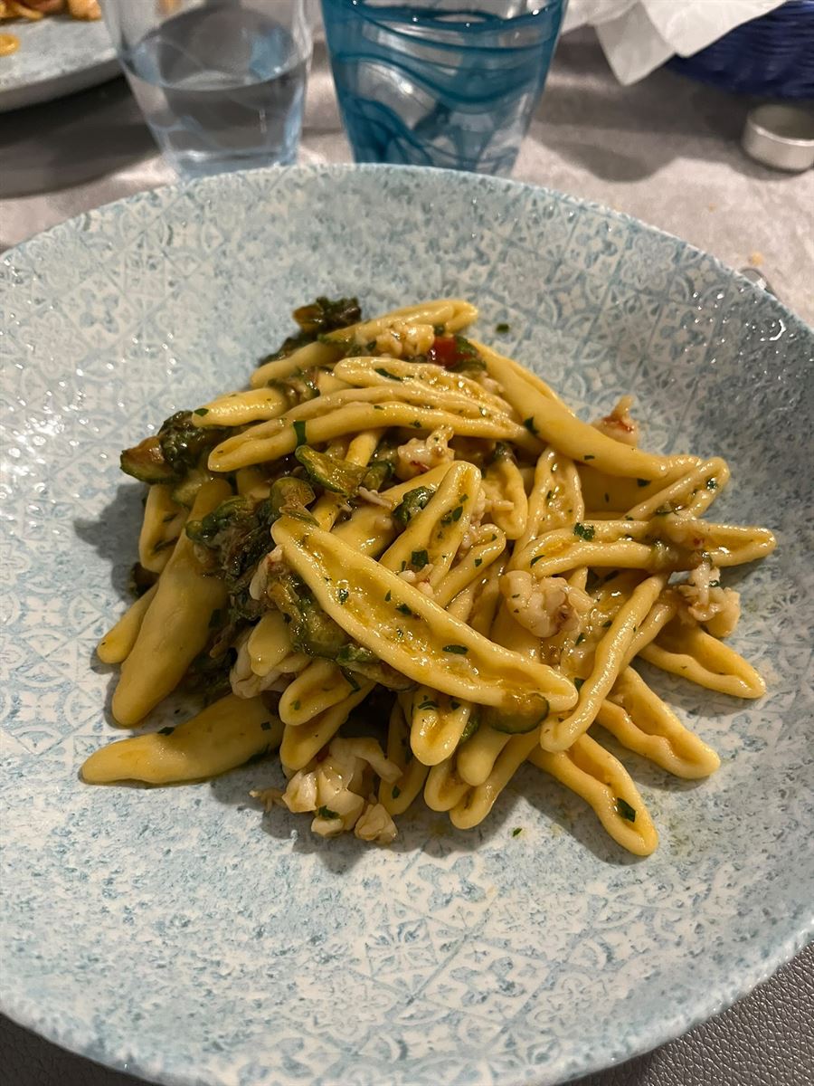 Cavatelli freschi con crostacei e zucchine su piatto decorato
